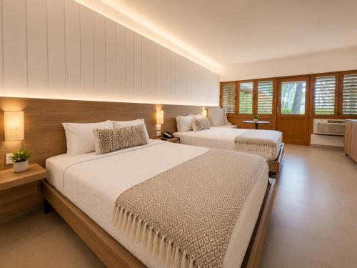a bedroom with two beds in a room at Copamarina Beach Resort & Spa in Guanica