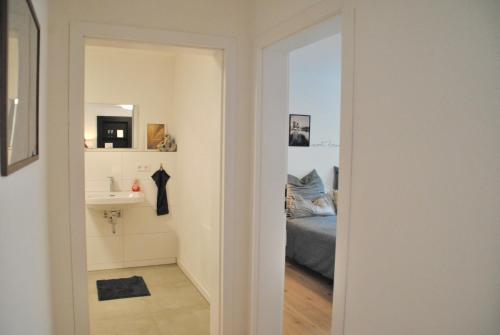 a bathroom with a sink and a mirror at Apartment la rosa in Weißensberg