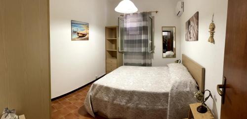 a small bedroom with a bed and a shower at Casa Sciavè - Paradise in Sciacca in Sciacca