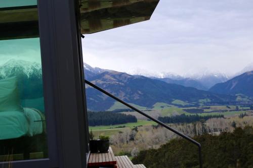 a room with a window with a view of mountains at Manakau PurePod in Kaikoura