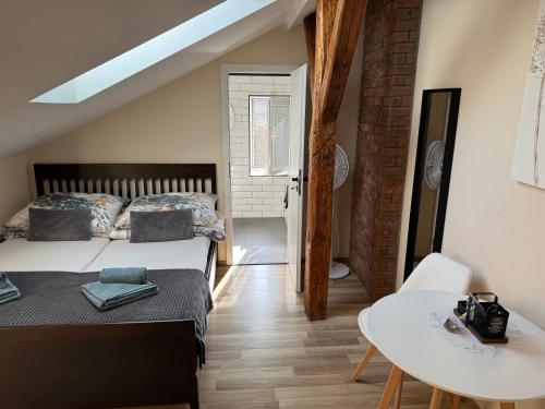 a bedroom with a bed and a table and a table at Apartmány Kukučín in Košice