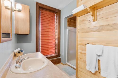 a bathroom with a sink and a window and towels at Del Norte Colorado Stone Quarry Studio Apt in Del Norte