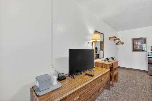 a living room with a television on a wooden dresser at Eagle Motel Suite 108 in Manitou Springs
