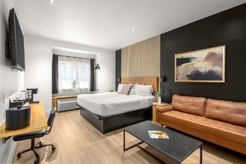 a hotel room with a bed and a couch at The Block Hotel Bentonville in Bentonville
