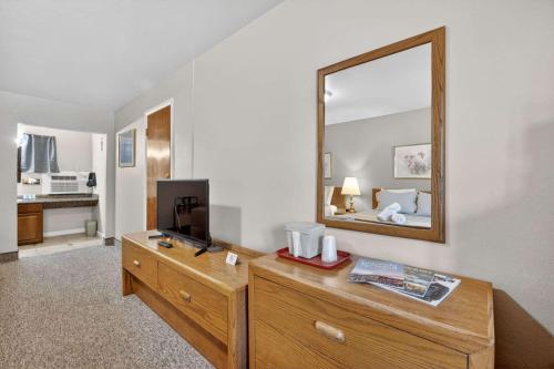 a room with a dresser with a mirror on it at Eagle Motel Suite 110 in Manitou Springs
