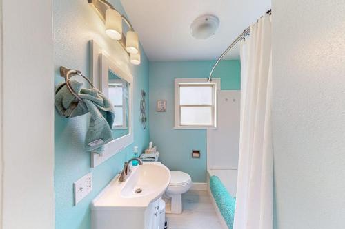 a blue bathroom with a sink and a toilet at Enchanting Adobe in Lead