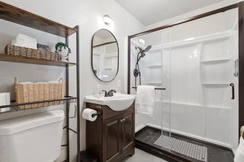 a bathroom with a shower and a sink and a mirror at Harmony Hideaway Hammocks Creek Sounds in Shaver Lake