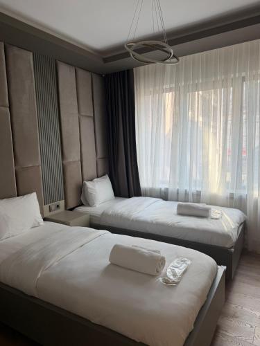 a hotel room with two beds and a window at Viva Nova Suit Hotel in Bakanlıklar