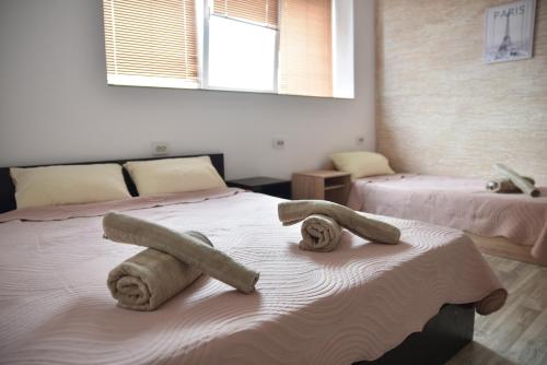 a bedroom with two beds with towels on them at Apartment Friends in Veles