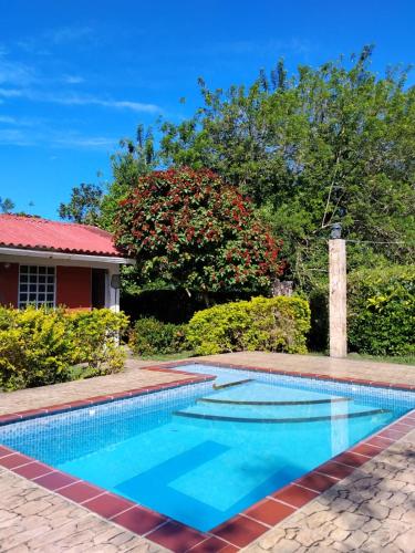 a swimming pool in front of a house at La Luna by JR in Mariquita