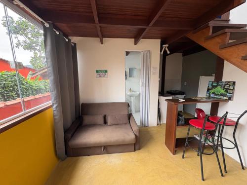 a room with a chair and a desk and a table at Mi casa Su casa Lofts - LOFT 5 in Angra dos Reis