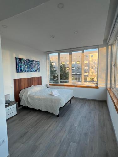 a bedroom with a bed and a large window at Fátima Serenity Apartments in Fátima