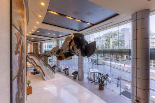 a dinosaur hanging from the ceiling of a building at Barceló México Santa Fe in Mexico City