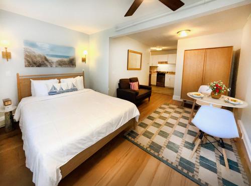 a hotel room with a bed and a living room at The Provincetown Hotel at Gabriel's in Provincetown