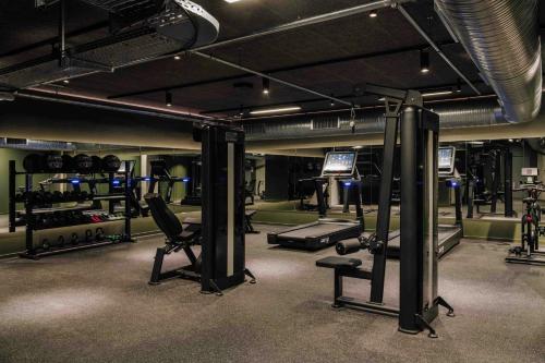 a gym with several treadmills and machines in it at Locke Copenhagen in Copenhagen