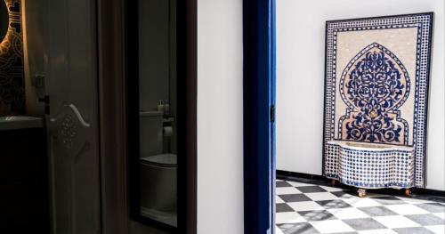 a bathroom with a toilet and a tile floor at Dar Mounia Les Oudayas in Rabat