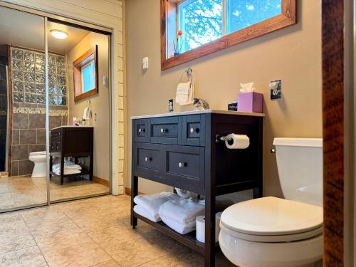a bathroom with a black cabinet and a toilet at Bearadise by Casago McCall - Donerightmanagement in McCall