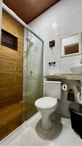 a bathroom with a toilet and a shower and a sink at Pousada São José in Barreirinhas