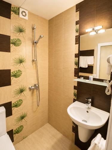 a bathroom with a sink and a shower at Hotel Rostov in Pleven
