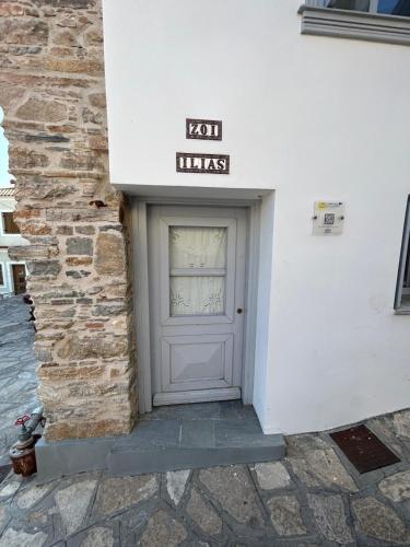 a door to a building with a sign on it at Samos Vista Azzurra 1 in Samos