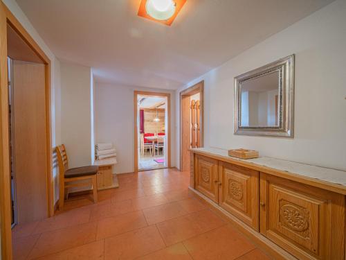 a bathroom with a counter and a mirror on the wall at Elisabeth II in Wald im Pinzgau