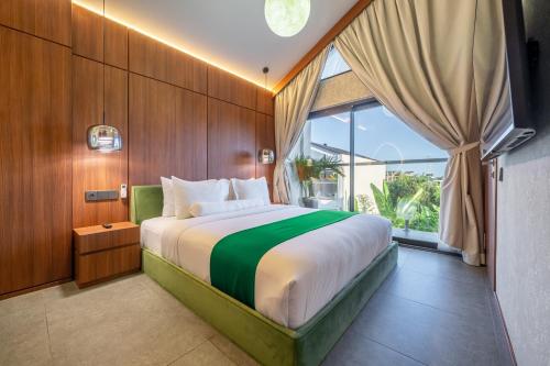 a bedroom with a large bed and a large window at U Villas - Tropical Views Luxury Stay with Pool & Workspace in Ungasan
