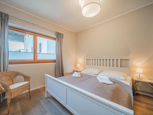 a bedroom with a large bed and a window at Kitz Apartments Top 7 in Kitzbühel