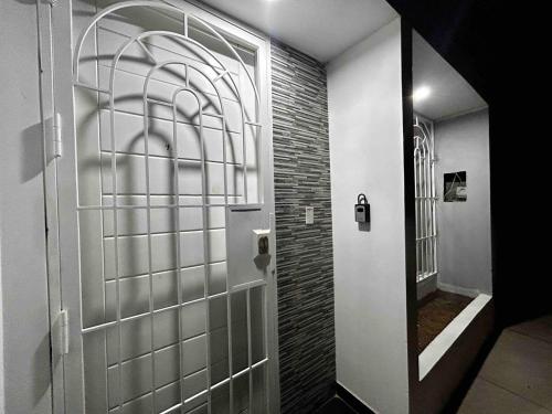 a hallway with a door and a brick wall at Cozy house in San Pedro