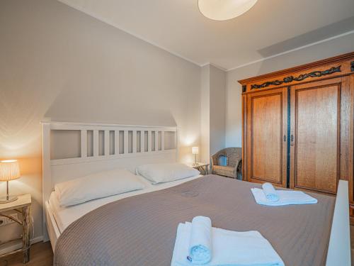 a bedroom with a large bed with towels on it at Kitz Apartments Top 6 in Kitzbühel