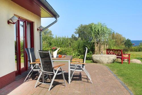 a table and chairs sitting on a patio at Haus an der Wiek in Wohlenberg