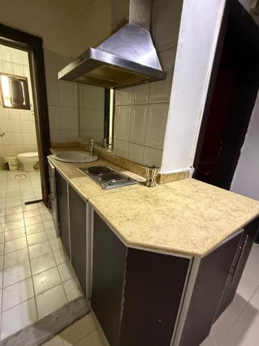 a kitchen with a sink and a stove at شقق مفروشة العزيزية in Hail