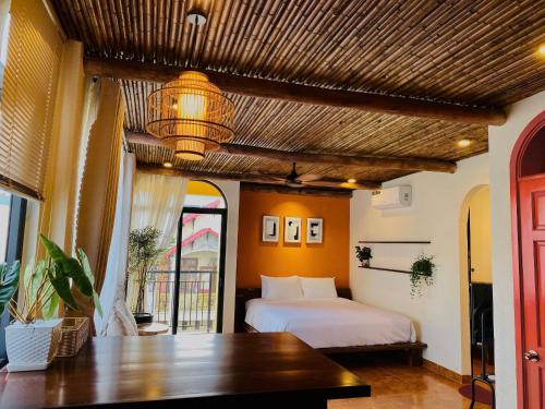 a bedroom with a bed and a table in a room at Staypineapple in Quy Nhon