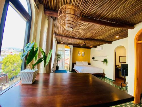 a large room with a bed and a large table at Staypineapple in Quy Nhon