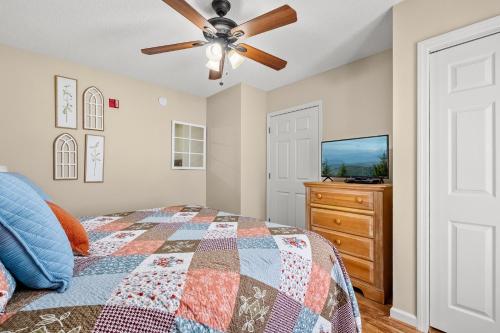 a bedroom with a bed and a ceiling fan at WP141 City Lights in Pigeon Forge