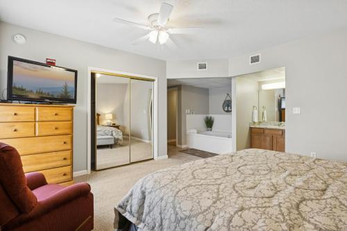 a bedroom with a bed and a dresser and a tv at WP521 We've Got It All in Pigeon Forge