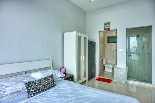 a bedroom with a bed and a bathroom with a shower at Tropics Condo in Petaling Jaya