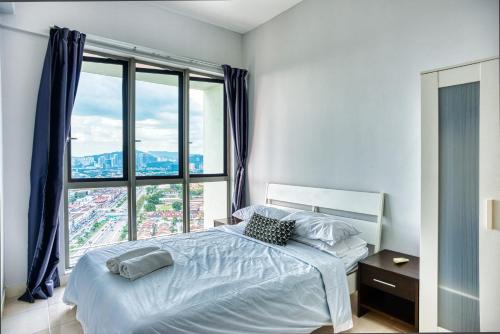 a bedroom with a bed and a large window at Tropics Condo in Petaling Jaya