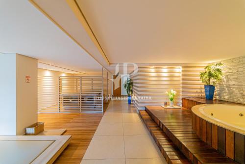 a bathroom with a tub and a sink at Apartamento a beira-mar com piscina in Cabedelo
