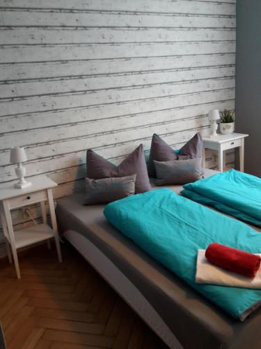 a bed with blue sheets and pillows in a room at Landhotel zur guten Quelle in Eisenach