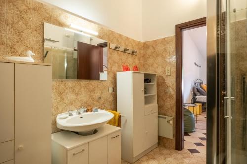 a bathroom with a sink and a mirror at Casa Anna in Paratico