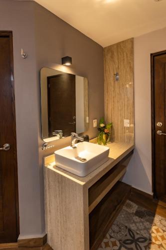 a bathroom with a sink and a mirror at Gran Vila Nai Boutique Hotel in Guadalajara