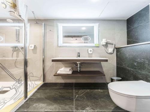 a bathroom with a sink and a shower at ibis Styles Lublin Stare Miasto in Lublin