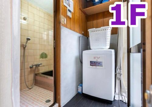 a small kitchen with a refrigerator and a shower at Kyo Yukari in Kyoto