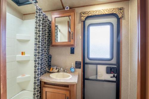 a small bathroom with a sink and a shower at Poop Deck in Fort Bragg