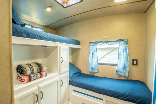 a room with two bunk beds and a window at Poop Deck in Fort Bragg