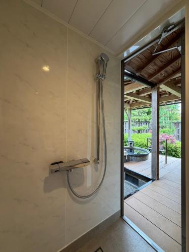 a shower in a bathroom with a glass door at Japanese Ryokan Seryo in Kyoto