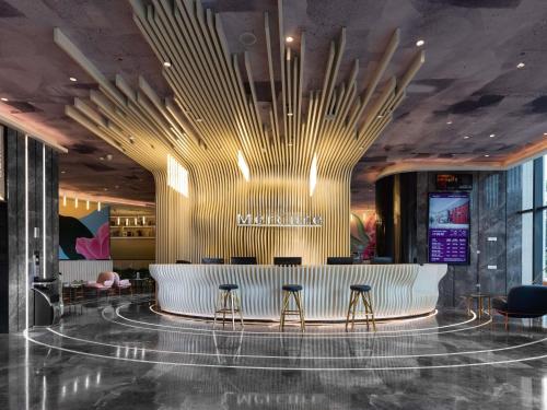 a lobby of a marriott hotel with a bar at Mercure Chengdu Xindu in Chengdu