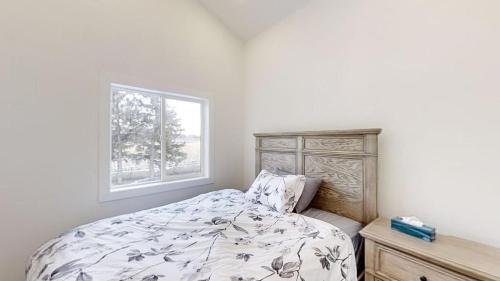 a bedroom with a bed and a window at Orchard Haven in Orono