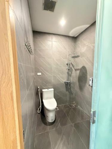 a bathroom with a toilet and a shower at Villa Flamingo Hải Tiến in Thanh Hóa