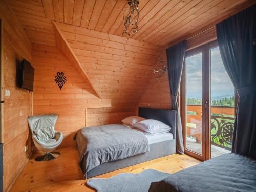 a bedroom with two beds in a wooden cabin at Luxury holiday villa, pool, sauna, jacuzzi in Nowy Targ
